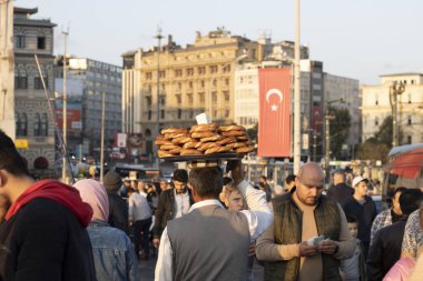 İstanbul, Türkiye - Ekim-27. 2019: Adam kafasındaki tepside simit satıyor. Para kazanmaya çalışıyorum. Etrafında insanlar var..