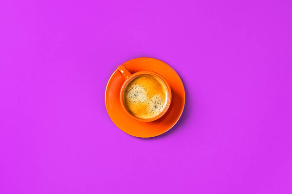 One cup of coffee on purple background.