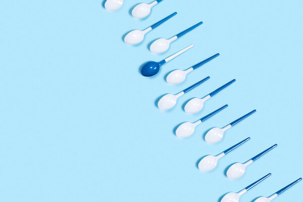 Pattern of withe spoons on blue background.