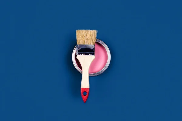 Blue background with paint jar and brush. — Stock Photo, Image