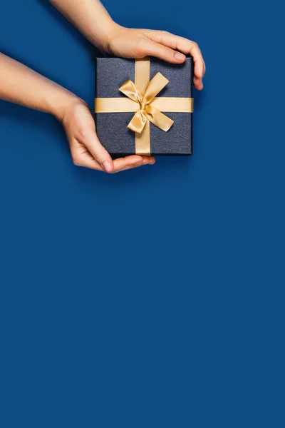 Hands with a gift box.