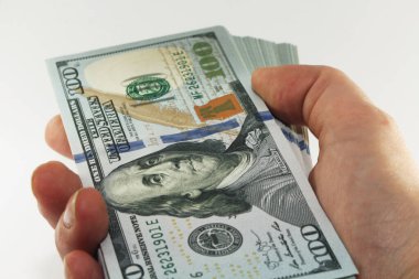 Elinde yığınla Amerikan parası, beyaz arka planda 100 dolar nakit para, bir sürü 100 dolarlık banknot.