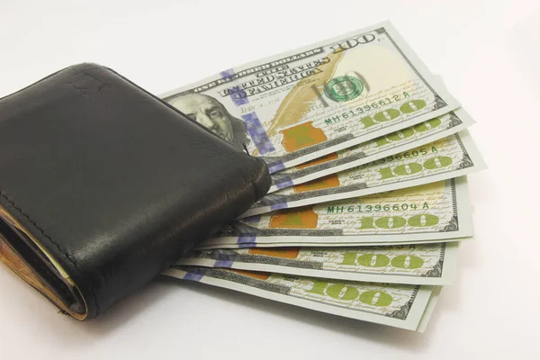 Hundred dollar bills in cash on black wallet