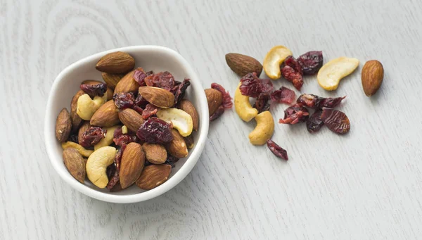 Healthy mix nuts on wooden background.
