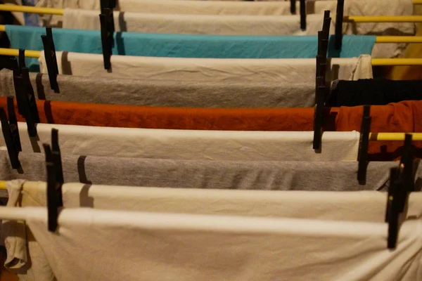 Clothes line with clean clothes indoors on laundry day