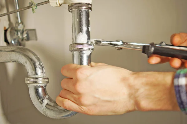 A plumber at work in the bathroom.