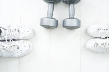 Fitness tracking concept. Running shoes flat lay view.