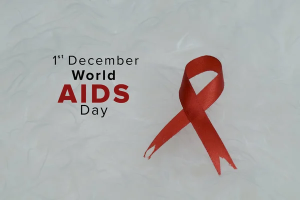 Aids red ribbon support for World aids day and national HIV/AIDS and aging awareness month concept