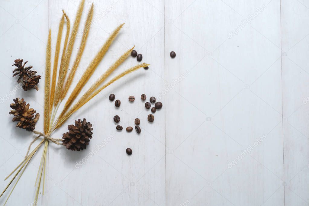 Desktop flat lay: dry flowers lying on wooden white background