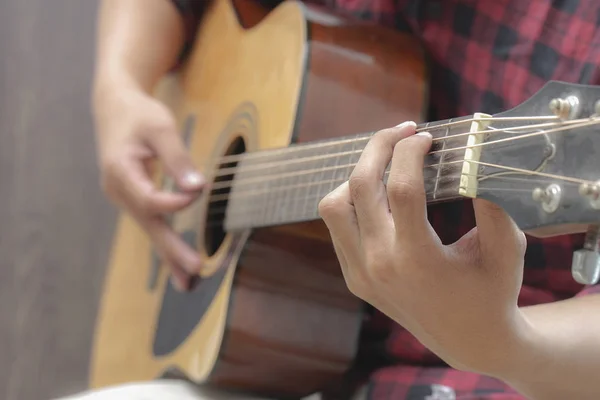 Acoustic Guitar Playing. Men Playing Acoustic Guitar Closeup Photography.