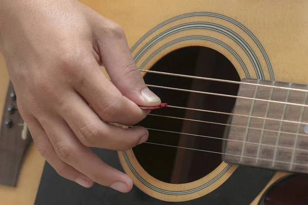 Acoustic Guitar Playing. Men Playing Acoustic Guitar Closeup Photography.