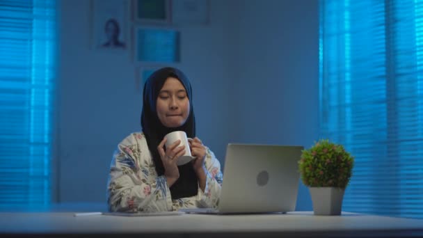 Sleepy Asian Muslims Wearing Dark Headscarves Drinking Coffee Working Home — Stock Video