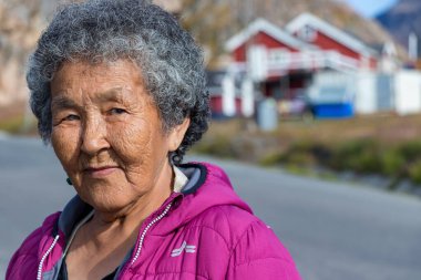 Portrait of a local inuit senior woman looking camera in Sisimiut, Greenland. clipart