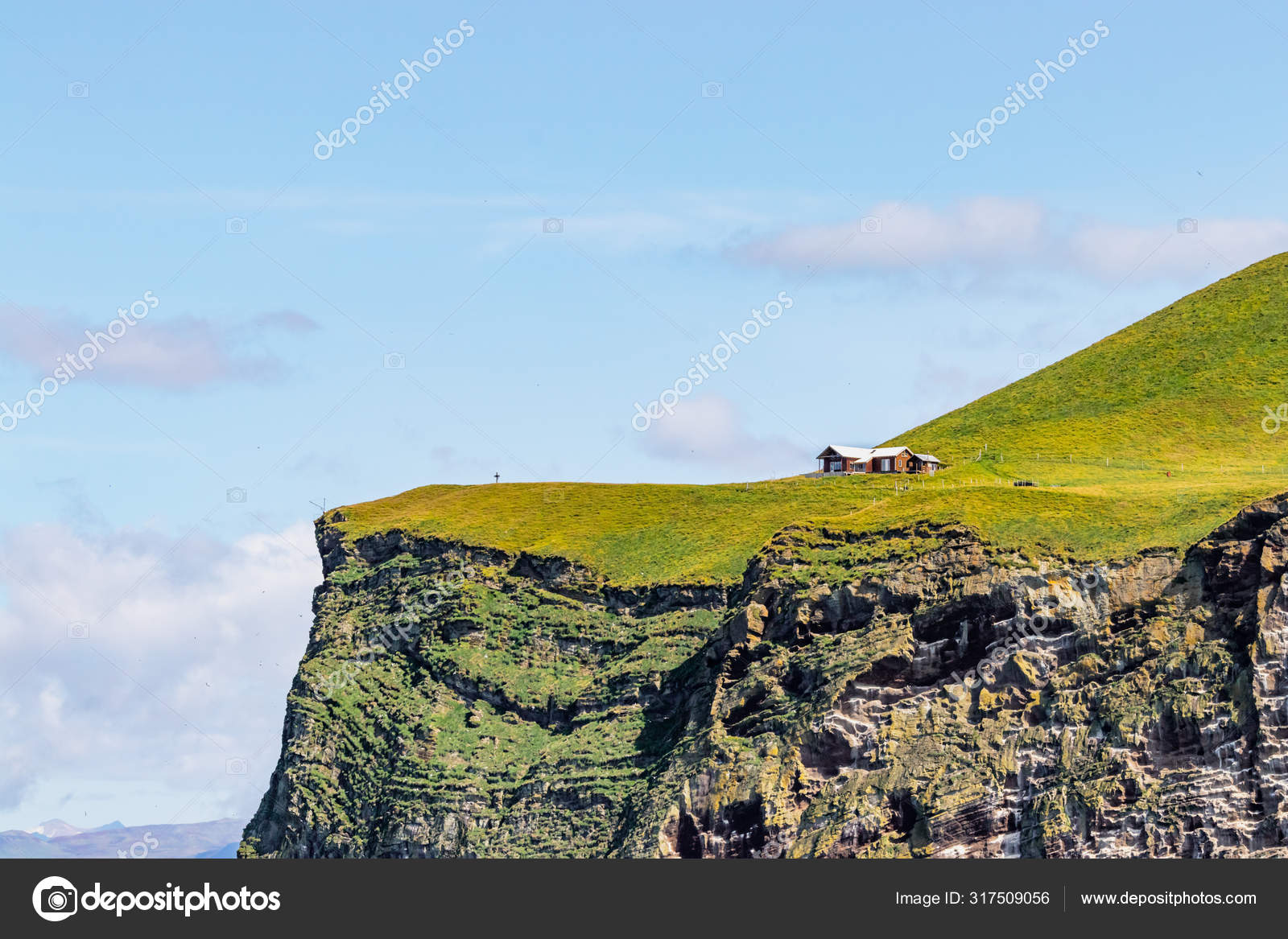 A guest house on the top of a cliff the Bjarnarey island next Heimaey
