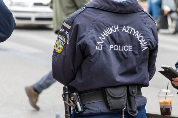 Astynomia police sign-logo on the back of a police uniform standing outdoors. — Stock Photo, Image