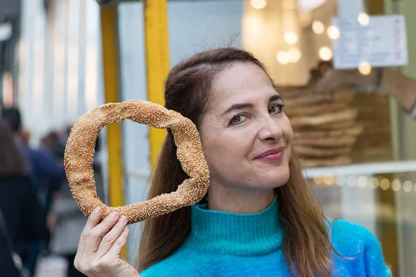 Greek woman holding a greek traditional koulouri.