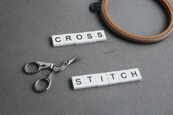 flat lay embroidery cross on a gray canvas