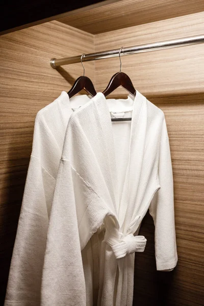 Two white shower gown hanged in the closet — Stock Photo, Image