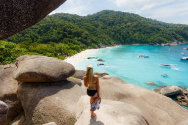 Genç bir kadın Similan adasında yelkenli kayanın üzerinde duruyor. Özgürlük yolcusu kadın Similan Ulusal Parkı, Phuket, Tayland 'da Similan No.8' de harika bir tabiata sahip. Seyahat kavramı