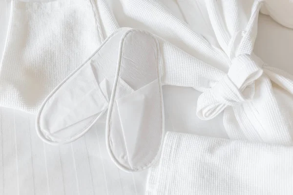 Roupão de banho e chinelos brancos e frescos, vista superior — Fotografia de Stock