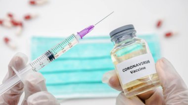 Covid-19 için aşı ve şırınga enjekte eden bilim adamı. Korona virüsü enfeksiyonunu önlemek, aşılamak ve tedavi etmek için kullanılır. Wuhan 'dan Coronavirus Hastalığı. Tıp konsepti.