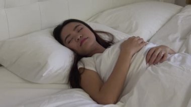4k, çekici Asyalı kadın yatakta uyuyor.