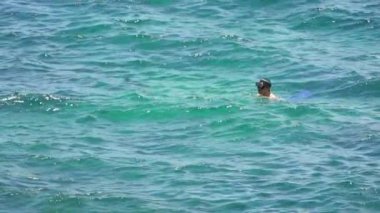 Keelung, Tayvan-16 Temmuz 2019: Deniz suyunda mayo, maske ve paletlerle şnorkelle yüzen adamın Yavaş Hareketi. Tropik bir adanın yaz tatilinde mavi okyanusta yüzmek.