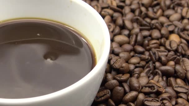 Una Taza Café Negro Sobre Granos Café Tostados Dan — Vídeo de stock