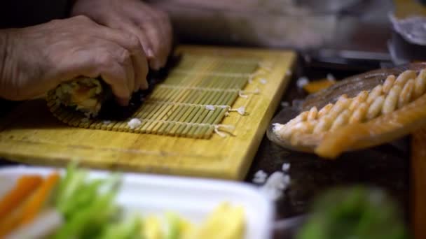 Makizushi正在准备 制作自制寿司和面包卷的过程 在家里或在厨房木桌上的餐馆里 男性厨师手准备日本传统食品的特写镜头 — 图库视频影像