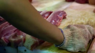 Kapalı eller tezgahta çiğ domuz eti hazırlıyor. Taipei pazarındaki bir dükkanda geleneksel Tayvan yemekleri satışı. Piyasada indirim var. Tayvan 'ın meşhur pazar yeri.