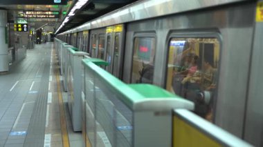 Taipei, Tayvan-29 Ağustos 2017: 4K Asyalılar Taipei 'deki metro istasyonunda trene binmek için yürüyorlar. Modern metro sistemi Tayvan 'daki istasyona varıyor. Tren geliyor ve insanlar Dan 'e biniyor.