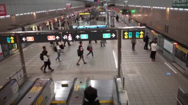 Taipei, Tayvan-16 Şubat 2017: 4K Asyalı insanlar metro girişindeki yürüyen merdivende Taipei 'deki tren istasyonuna gidiyor. Tayvan 'daki modern metro sistemi.