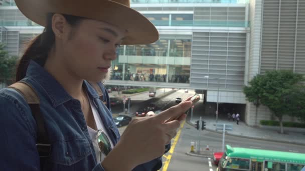 4K亚洲女青年在香港街上用智能手机快速发短信 检查她的电话 并与她的朋友使用在线 社交网络 Line Social Network Dan 来写短信 — 图库视频影像