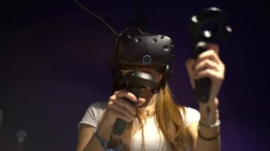 Taipei, Tayvan-01 Aralık 2017: 4K Asyalı kadın gözlük takıyor ve odada sanal gerçeklik oyunu oynuyor. Video oyunları ile birlikte bir baş montajlı ekran kullanıldı. VR modern teknoloji-Dan deneyimi