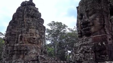 4K, Antik taş, Bayon tapınağının heykeline bakıyor. Angkor Thom, zengin dekore edilmiş bir Khmer tapınağı ile Asya 'nın popüler bir turistik merkezidir. Huzurlu taş yüzlü Kamboçya 'nın ünlü simgesi.