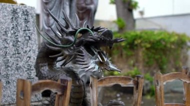 Japonya tapınağındaki Shinto tapınağında Temizu olarak bilinen tören arınma ayini için Japon su temizleme pavyonunun Yavaş Hareketi. Japonca senkronizasyon.