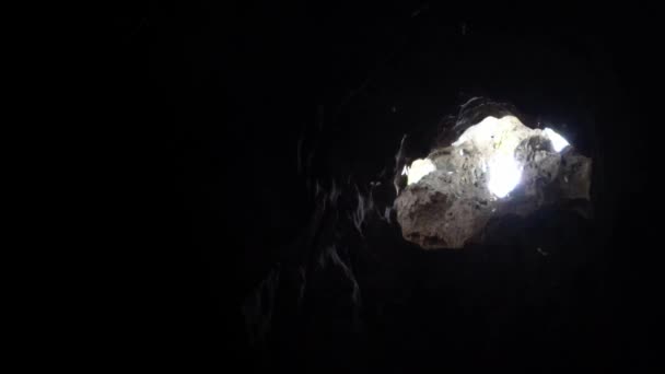 マレーシアの美しい自然の石灰岩の洞窟の中の太陽光線でゆっくりと飛行バット狩り 小さなコウモリは Batu洞窟の丘ダンに位置する暗い洞窟の穴を通って日当たりの良いビームライトで飛ぶ — ストック動画