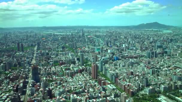 ビルの上から山と雲を背景にした台北市中心部のビルの4K空中風景101 西エリアの街並み台湾のスカイラインを望む高角度キャピタルデイタイムダン — ストック動画