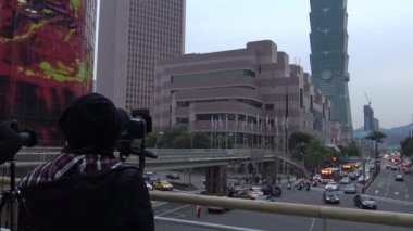 Taipei, Tayvan-29 Mart 2016: 4K. Asyalı fotoğrafçı Taipei 'deki ünlü bina 101' in DSLR kamerasıyla fotoğraflarını çekiyor. Tayvan-Dan 'de şehir manzarasını fotoğraflayan fotoğrafçı