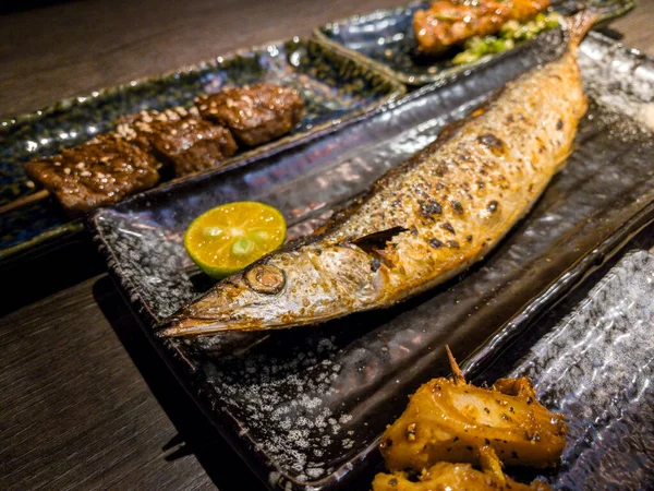 おいしい伝統的な串焼きと夕食のための魚のセット レストランで人気の日本料理 木製のテーブルの上に日本の串プレートを食欲をそそる — ストック写真