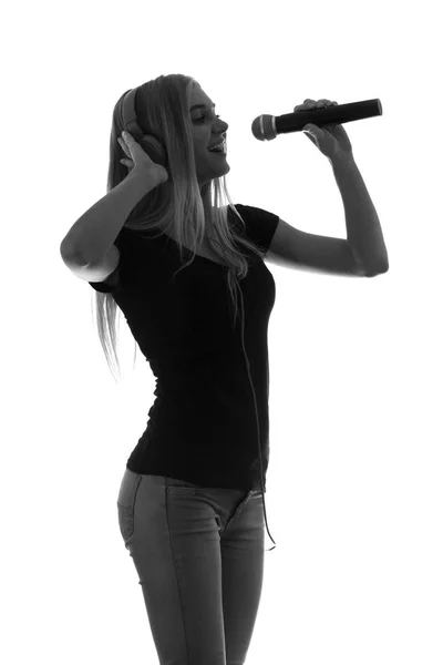 Ritratto di una bella donna in cuffia e con microfono — Foto Stock