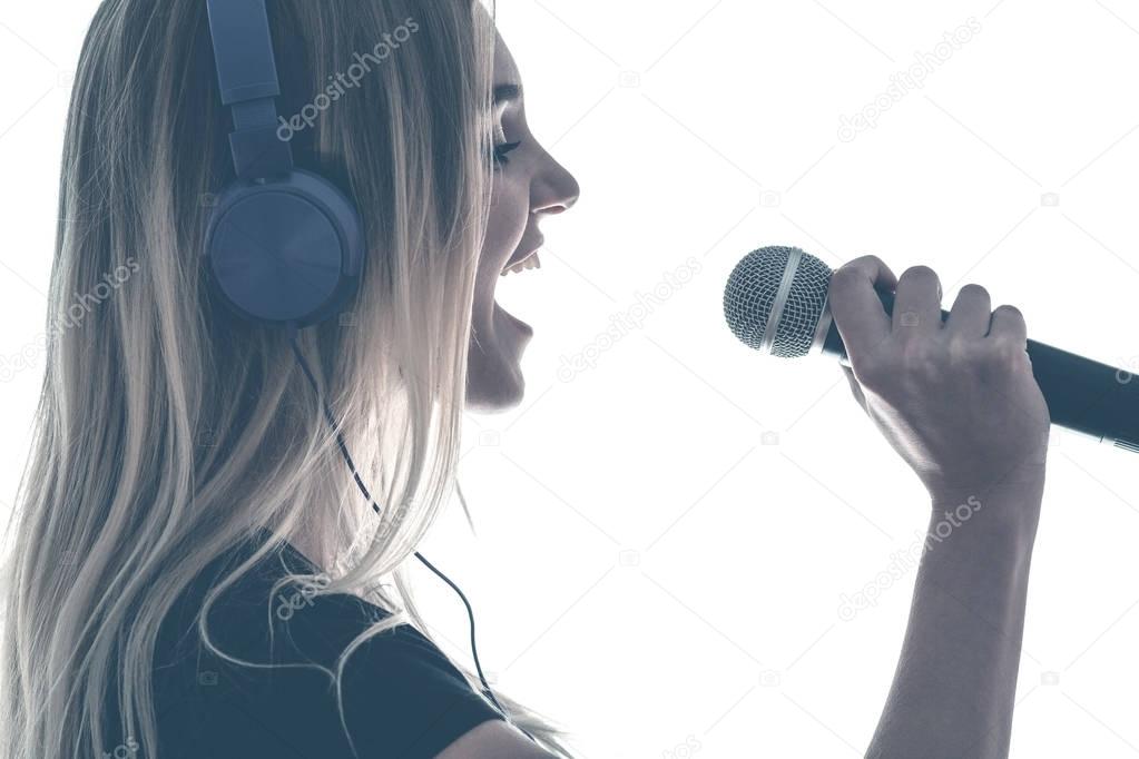 Vintage portrait of a young woman emotionally singing her favorite song