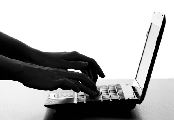 Silhouette of a female hands typing on the keyboard — Stock Photo, Image