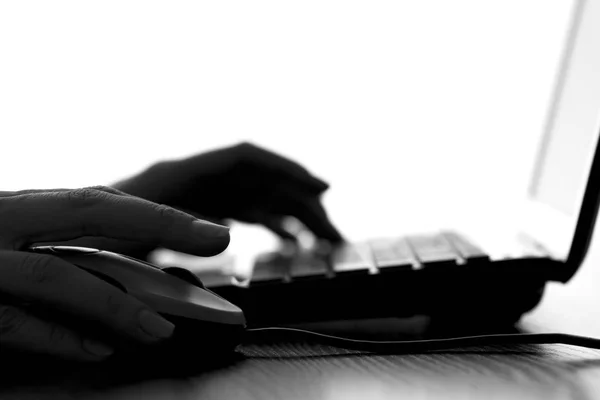 Silhouette of a female hands typing on the keyboard — Stock Photo, Image