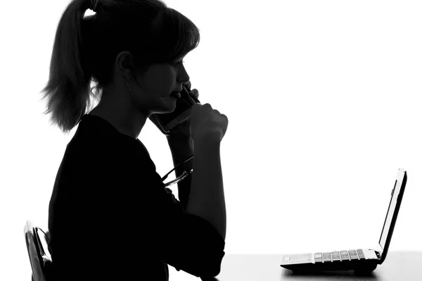 Silhouette of a young woman makes a purchase order by phone on the Internet — Stock Photo, Image