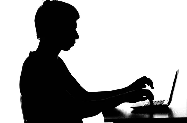Silhouette of a man working on the computer remotely — Stock Photo, Image