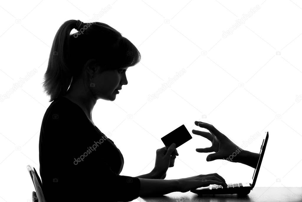silhouette of a woman shows the danger of online shopping by card
