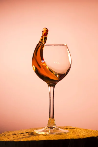 Glas mit Cognac, das aus ihm strömt — Stockfoto