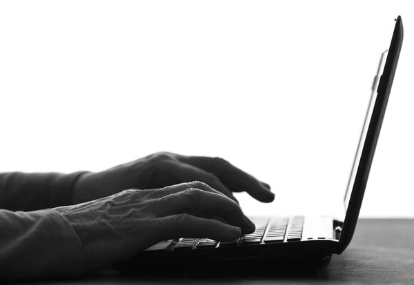 Silhouette of hands of an elderly woman typing — Stock Photo, Image