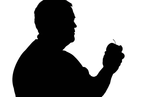 Silhouette eines übergewichtigen Mannes mit einem Apfel in der Hand — Stockfoto